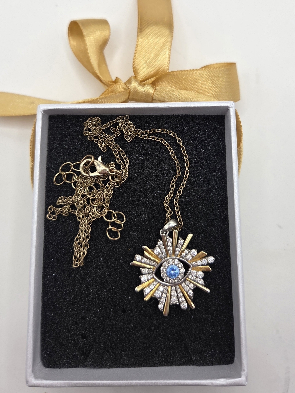 Evil eye sunburst necklace. Gold, silver, blue.